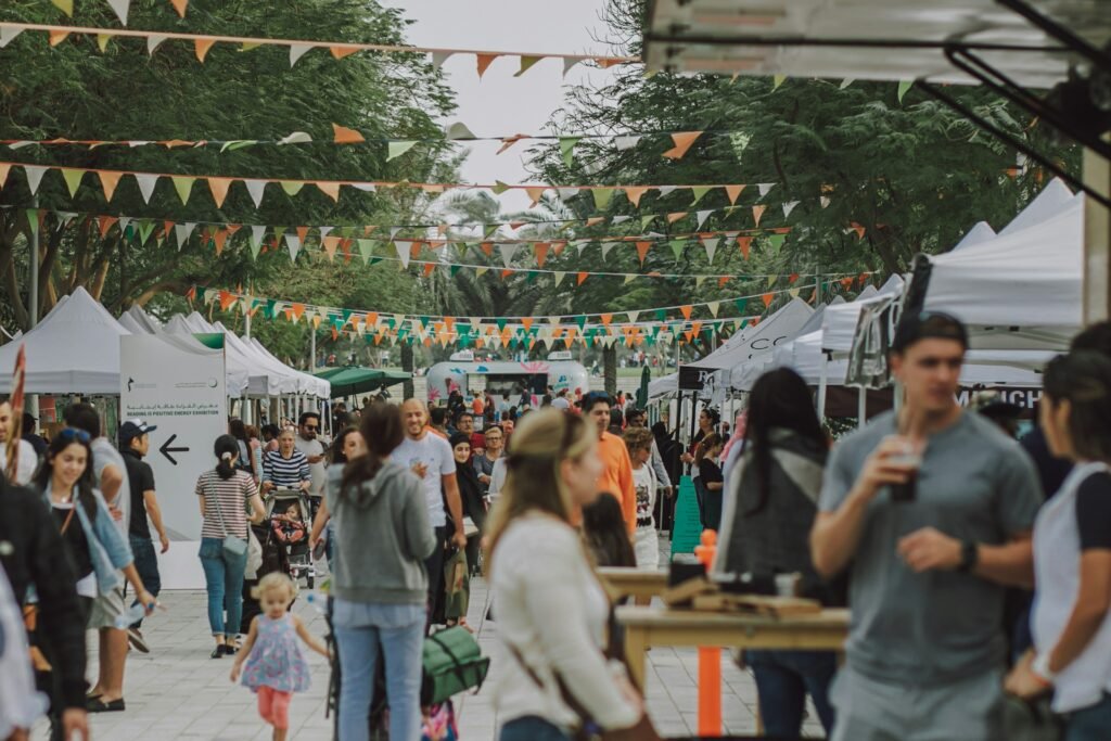 People enjoying a festival near a hotel