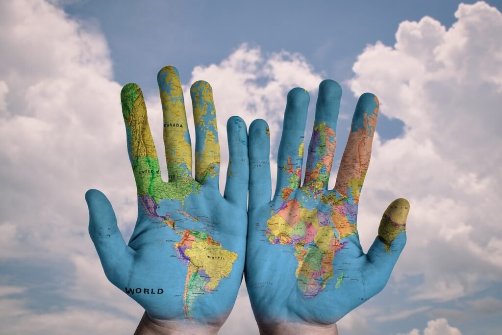 hands with the map of the globe painted on them for international seo with hotel brands