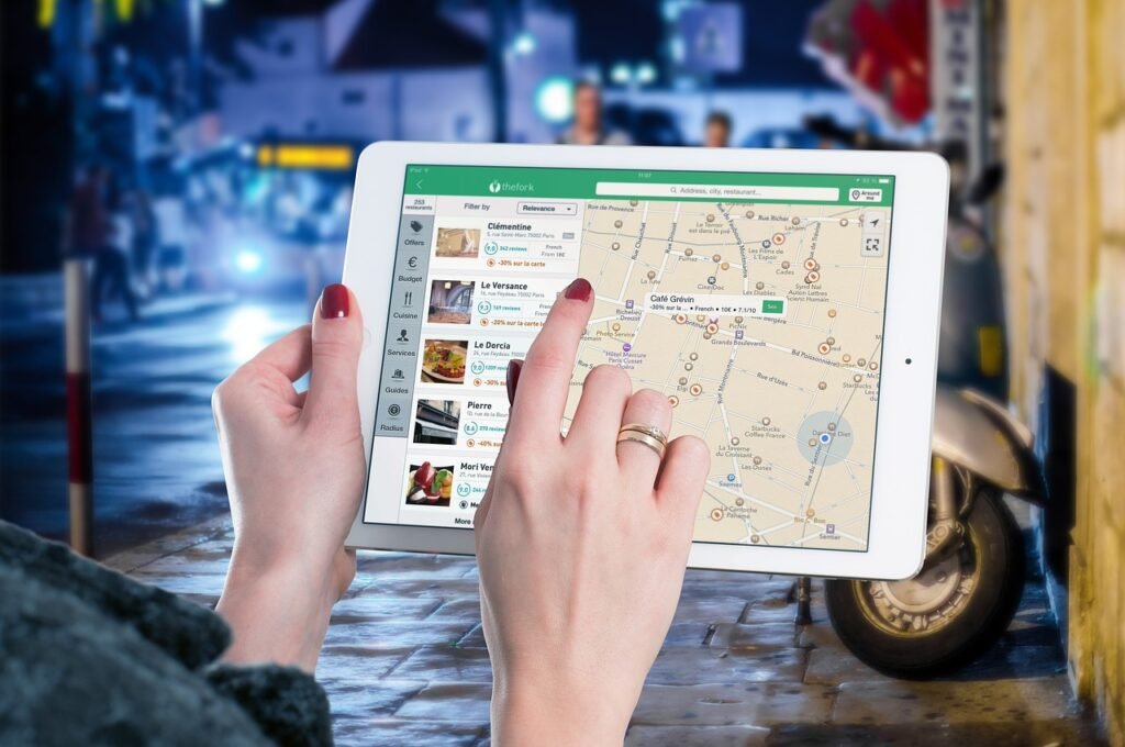 women holding up a tablet browsing the local seo map results