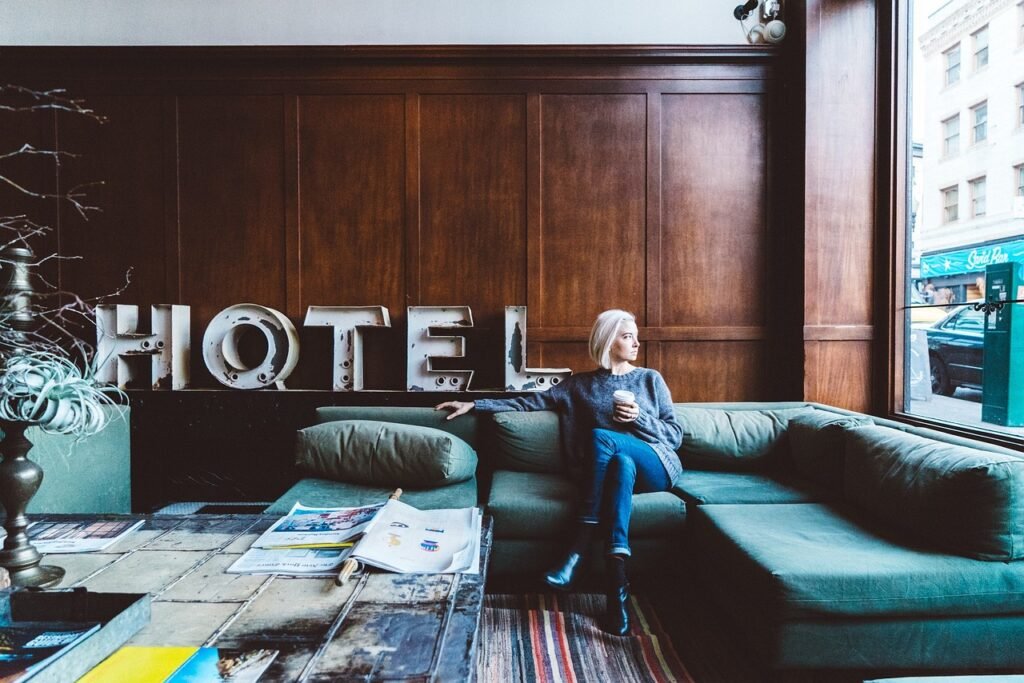 Guest sitting on a couch in a hotel lobby