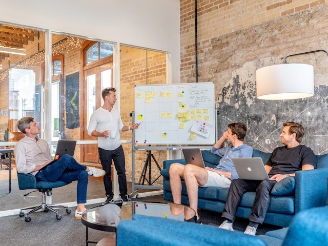 SEO team designing a hotel SEO content strategy on a whiteboard in a conference room