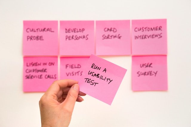 Sticky notes with important steps to improve a business, such as running a usability test to increase conversion rates