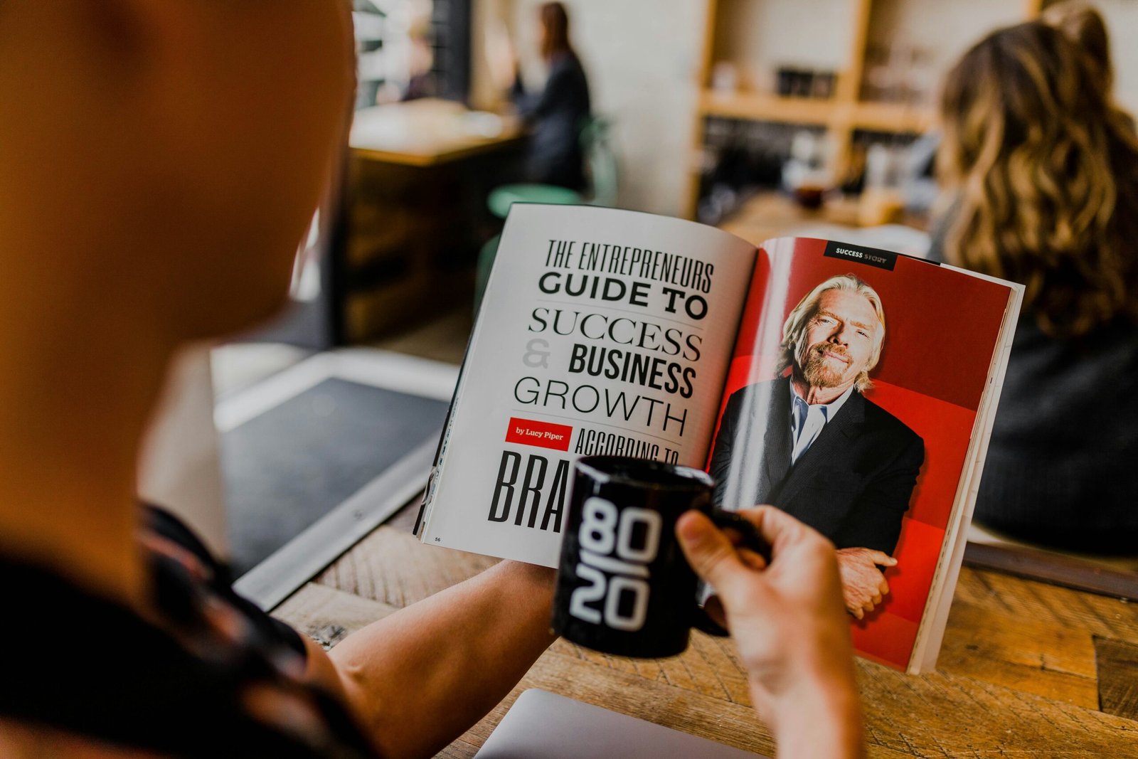 Man holding a magazine and a coffee cup learning about B2B content marketing