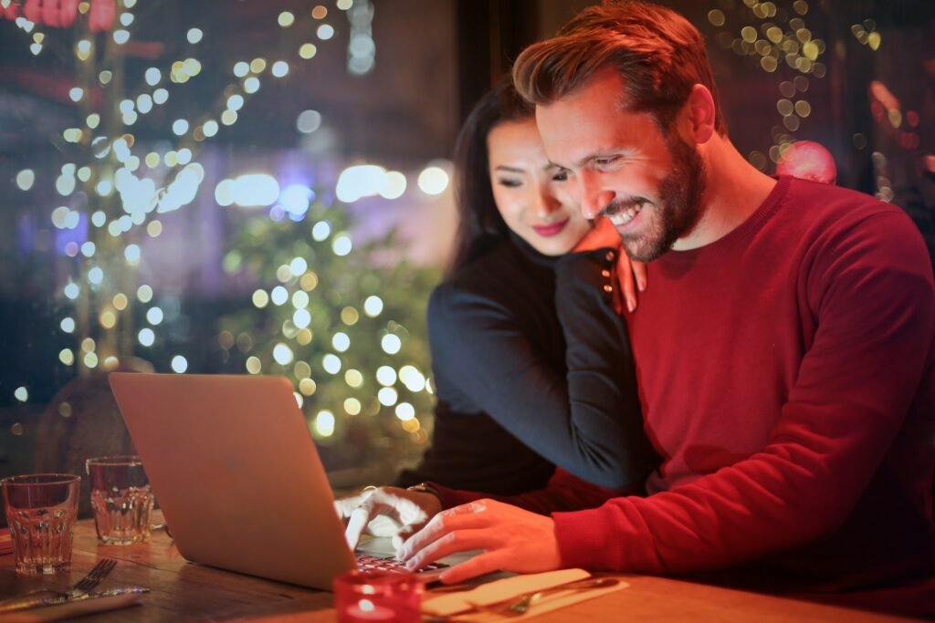 Couple booking a hotel on a hotel website on their laptop