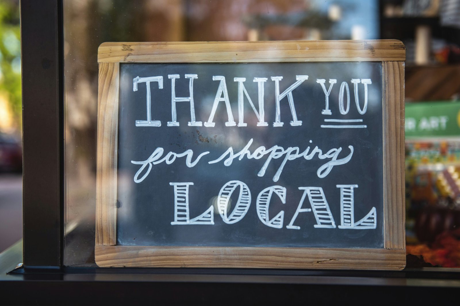 Local storefront sign potraying the importance of generating organic visits for your Google Business Profile